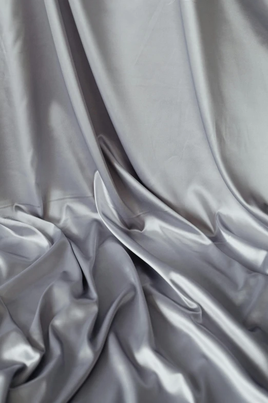 a close up of silver fabric with an intricate design