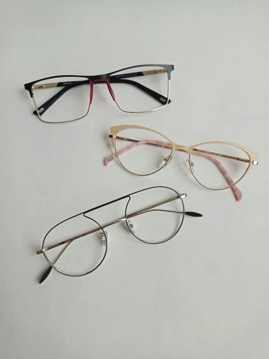 three pairs of glasses sit next to each other