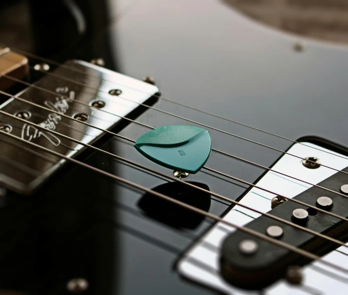 an electric guitar with black and white fretboard