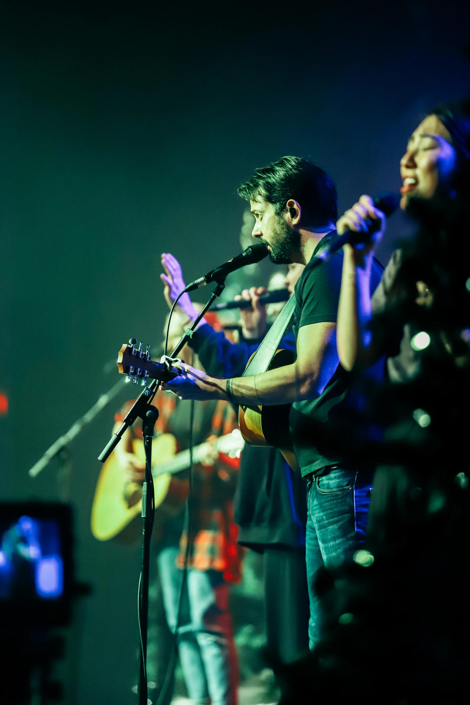 a band performing on stage in the dark