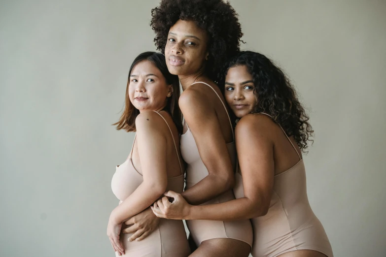 three women in underwear are posing for a pograph