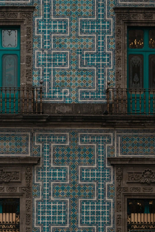 two buildings side by side with intricately tiled walls