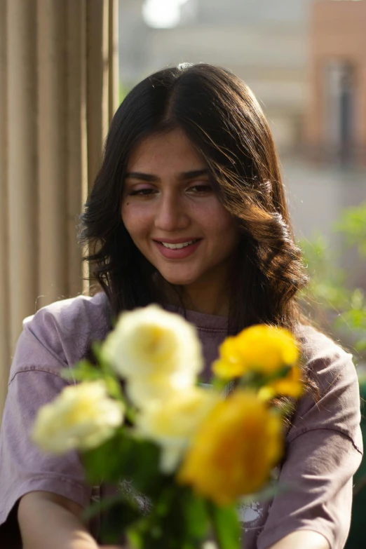 a woman in a pink top with yellow and white flowers