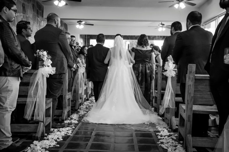 the bride is walking down the aisle at her wedding