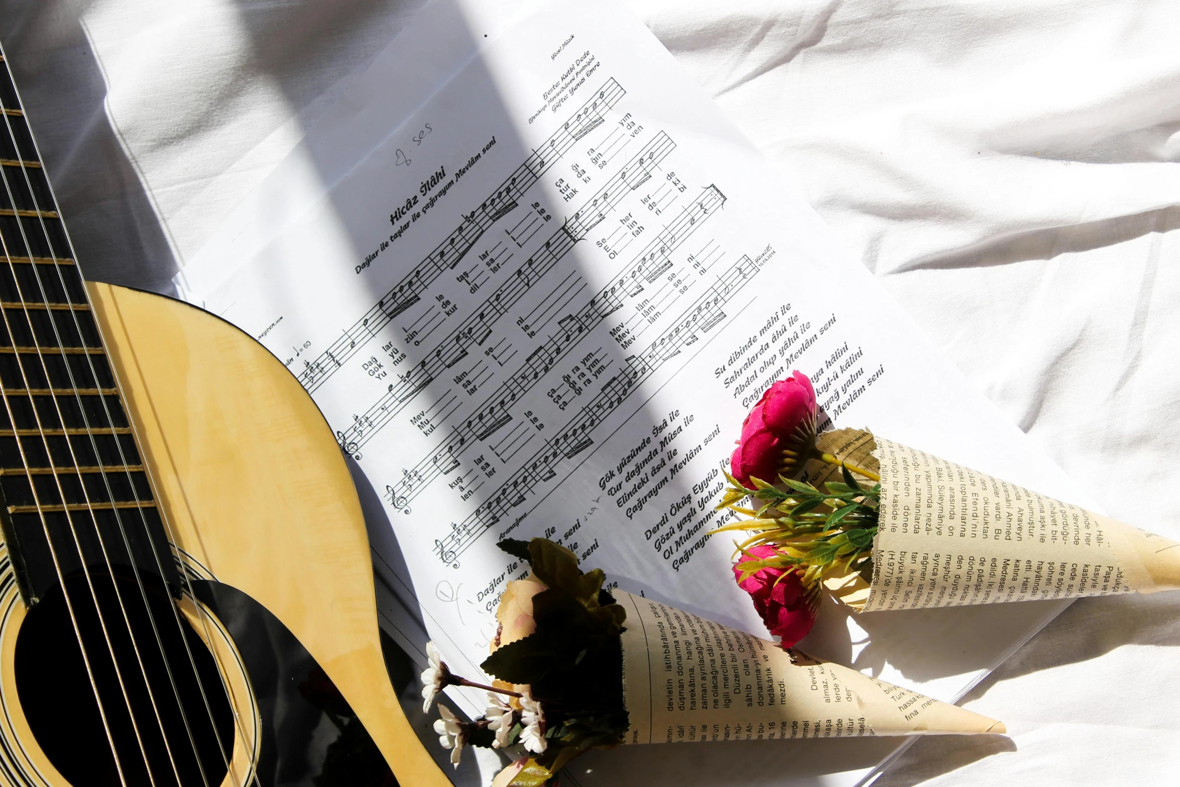 an old book lies open with a guitar in front