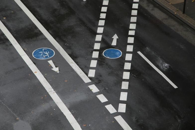 an overhead view of two blue arrows and some signs