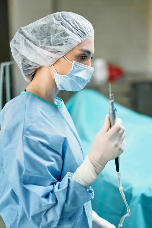 a nurse taking notes on a device in the operating room