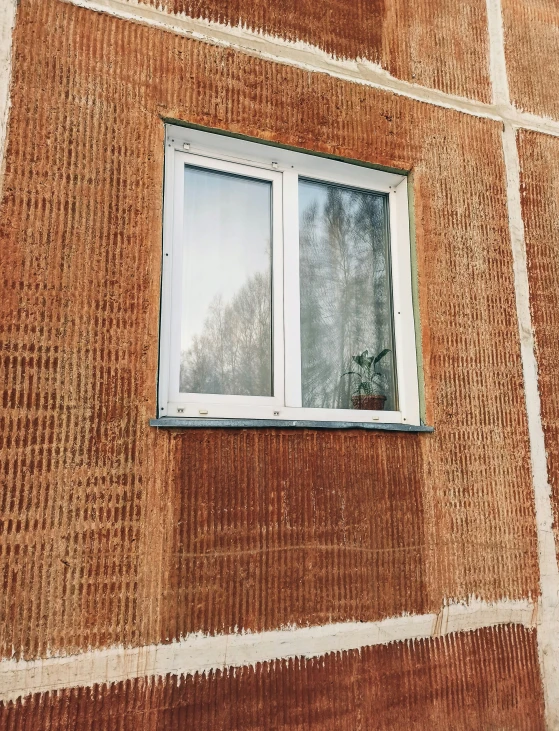 a window that is on a brick wall