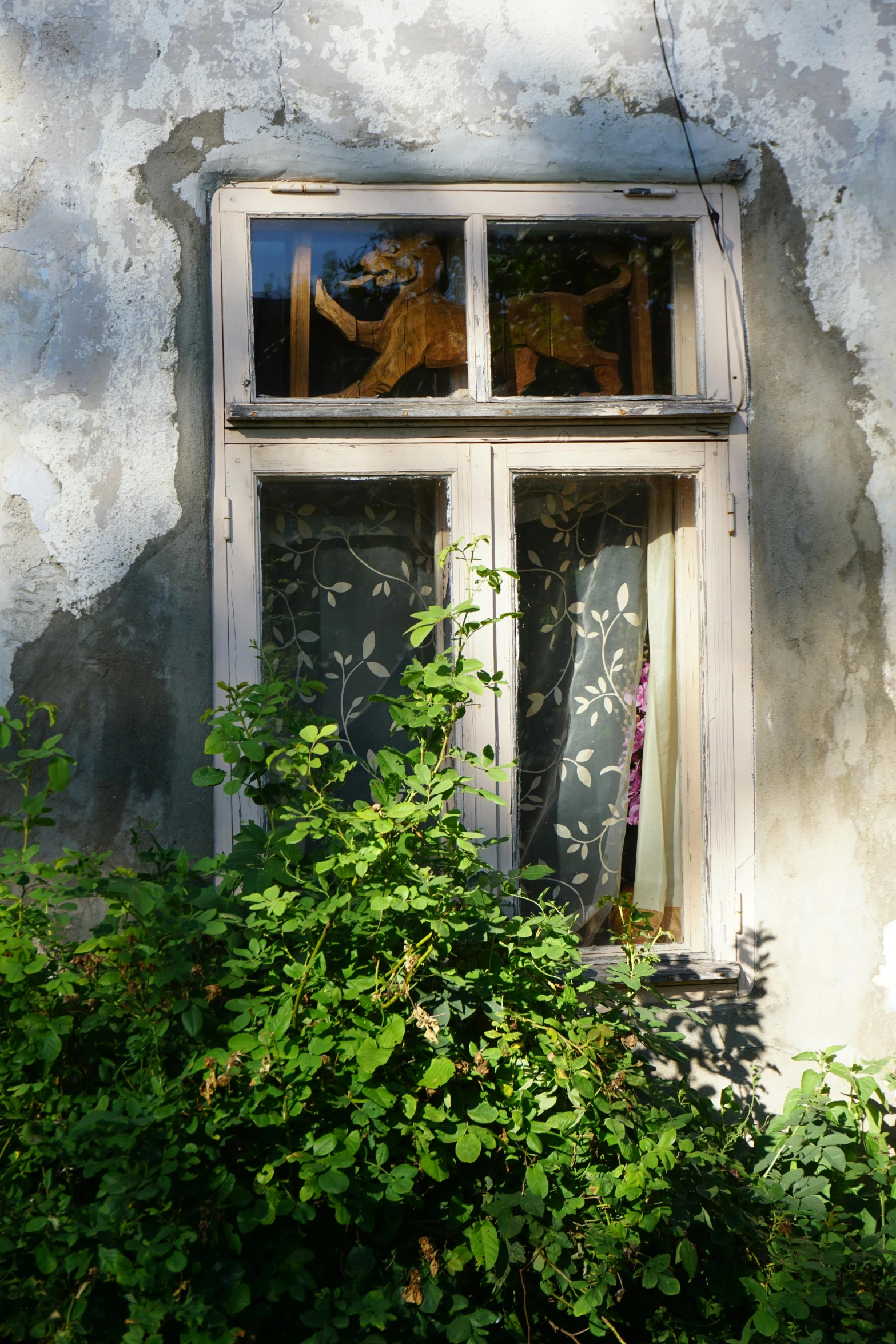 a very small window with an older woman figure in it