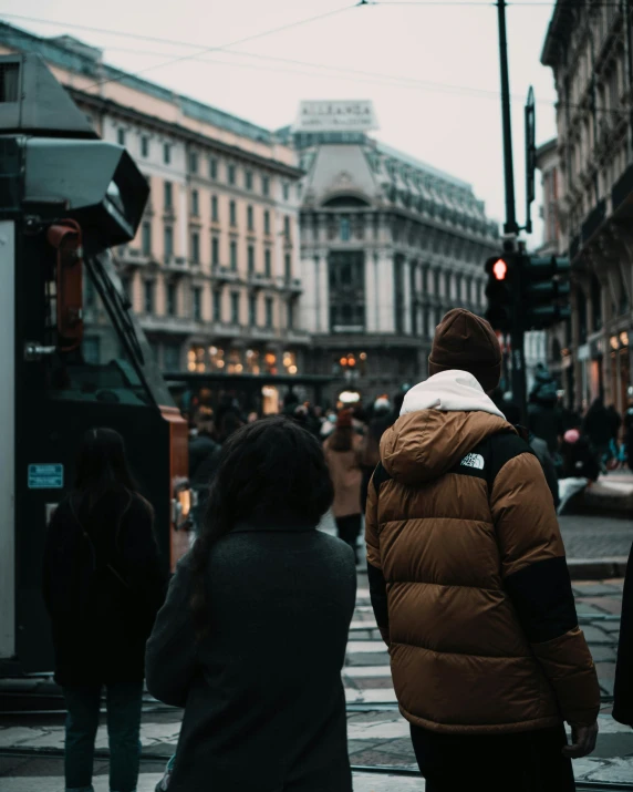 a person in a puffy jacket crossing the street