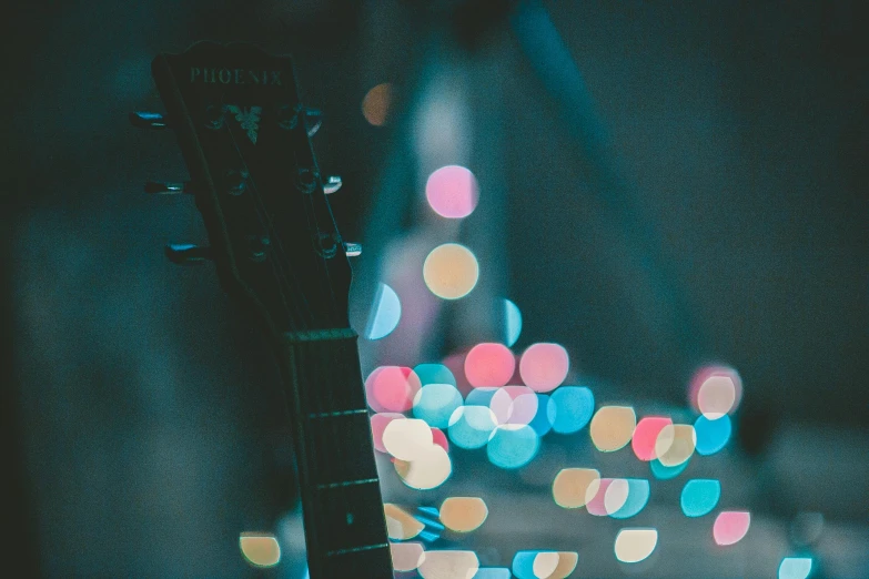 an electric guitar on a dark background in blurry colors