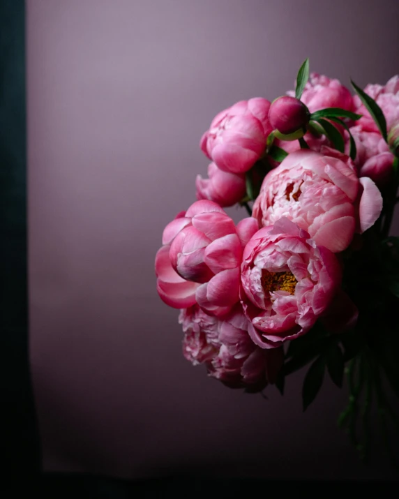 the bouquet of flowers is full of pink peonies