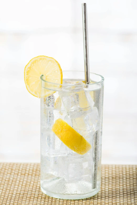 a lemon wedge sticking out of the glass with water in it