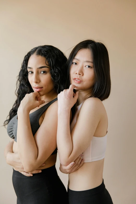 two young asian women in underwear, one wearing a white 