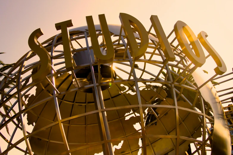 the sculpture is made of metal with lettering on it