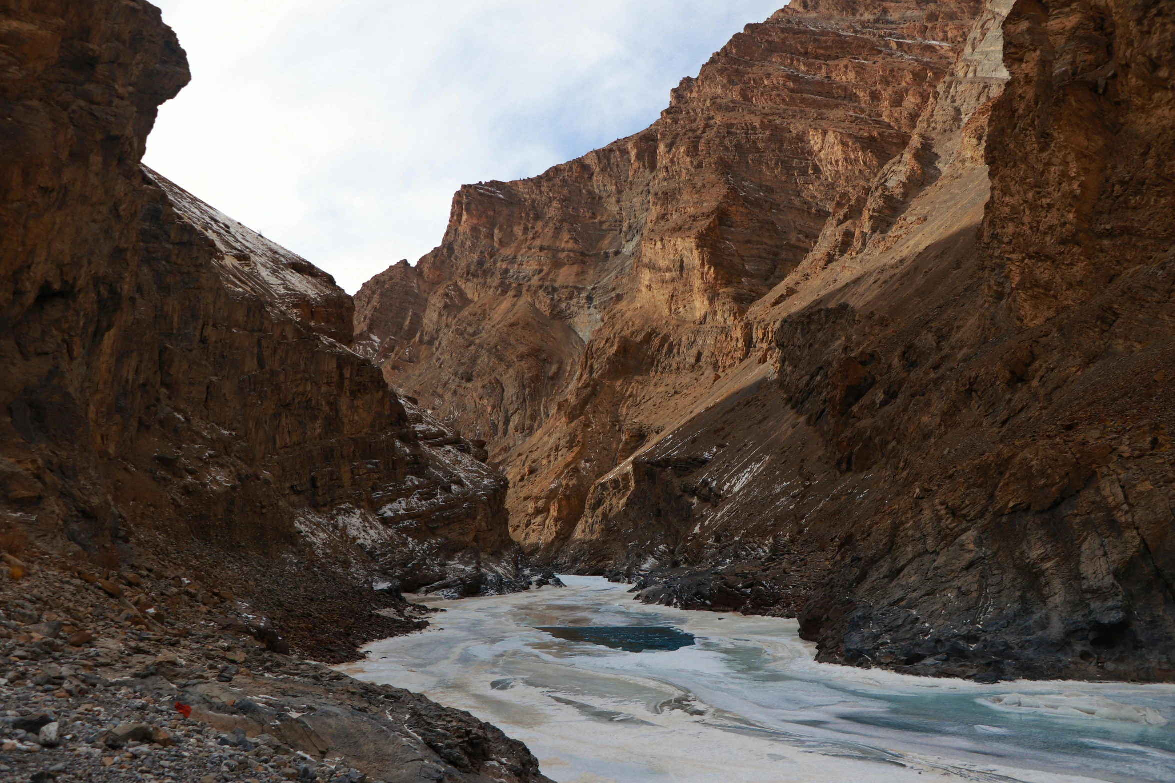 a small river runs through a narrow canyon