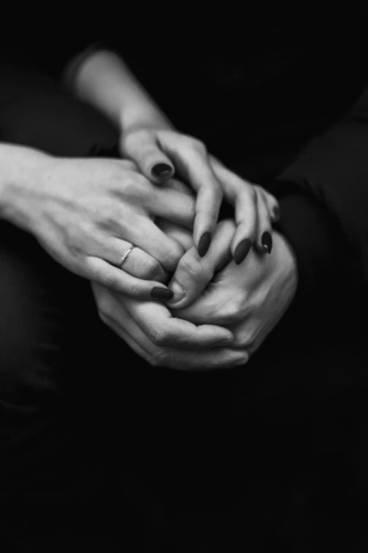 black and white pograph of hands holding each other