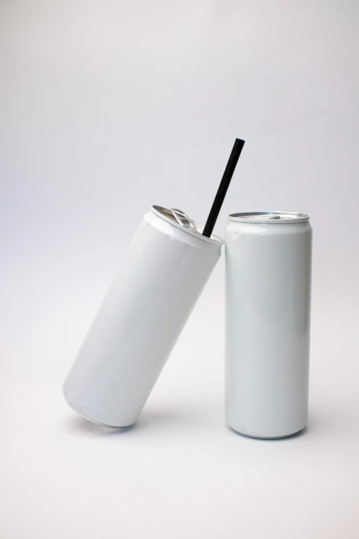 a white and black can with a straw inside