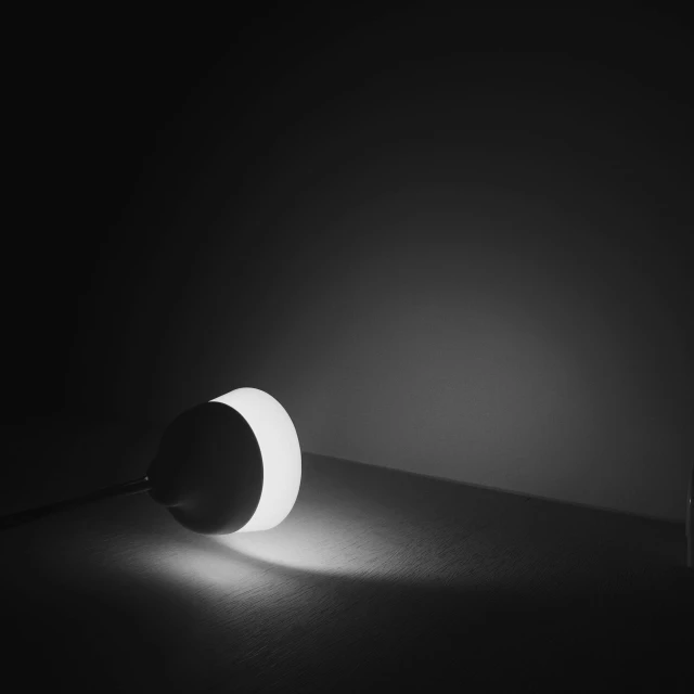 a circular light sitting on top of a black floor