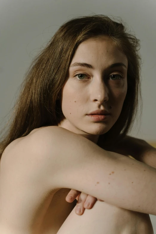 a  woman with freckled hair sits 