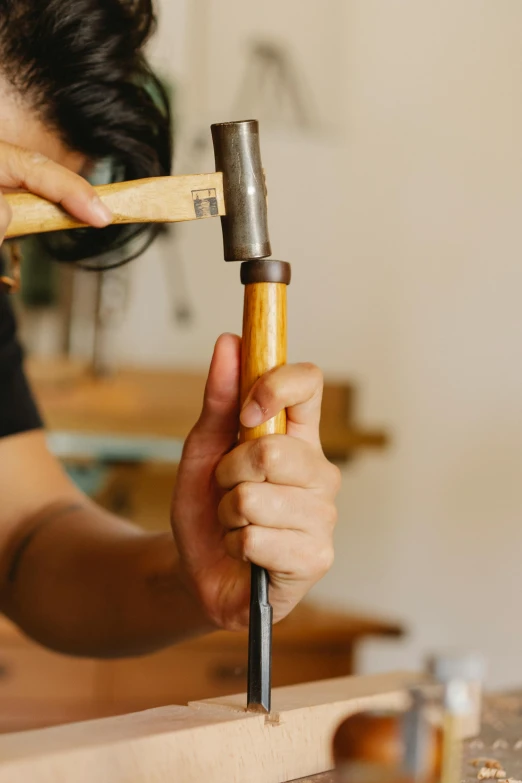 a person that is holding some tools in one hand and has soing in the other