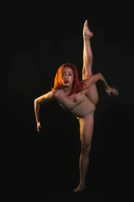 a female in a tan dress doing a handstand