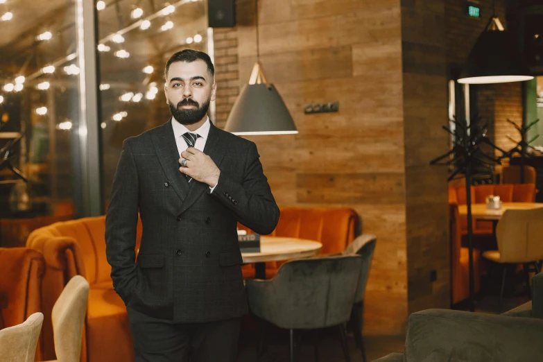 a man in a suit is standing near a table