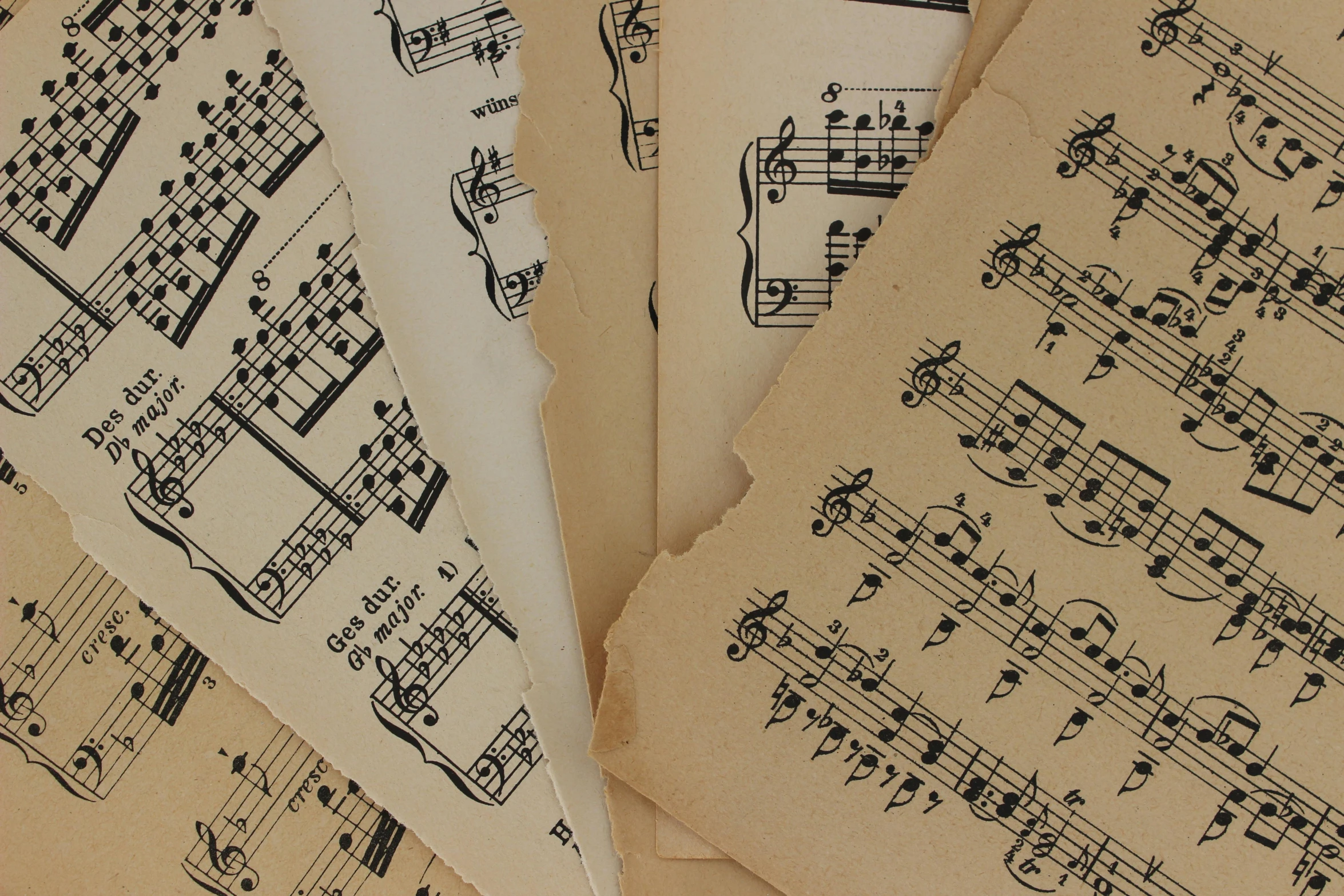 five old sheet music sheets covered in black musical notes