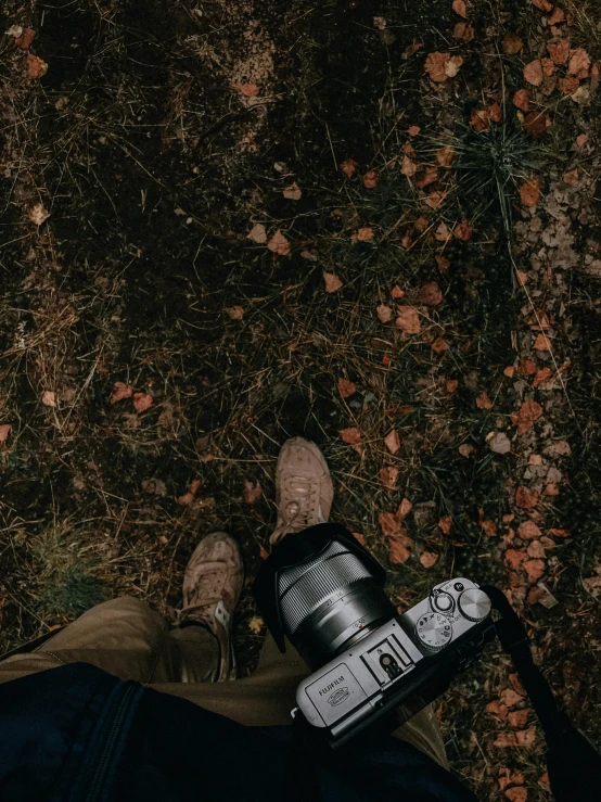 someones foot next to a camera with its flash on