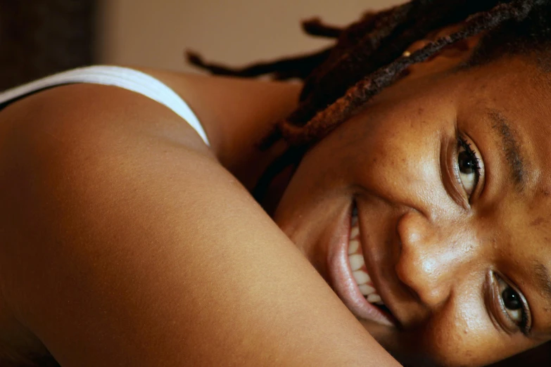 a close up view of a young woman wearing dreadlocks