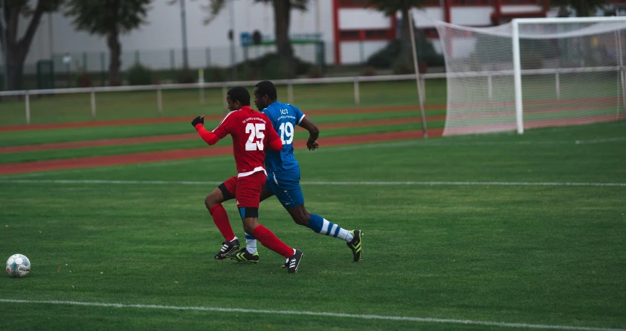 the men are playing soccer in the field