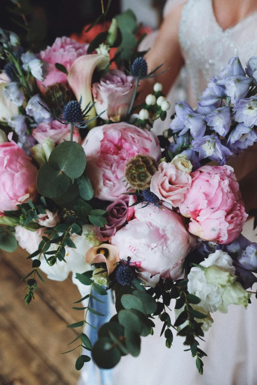 a bride holding her bouquet of flowers in her hands