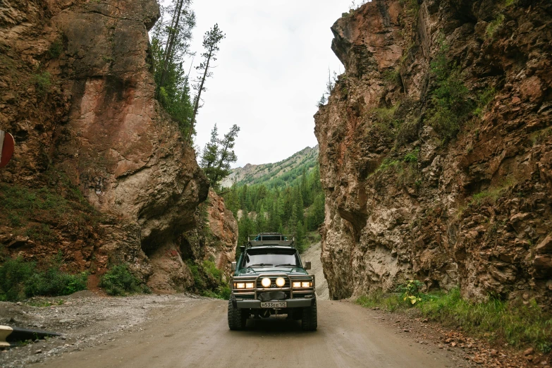 a truck that is driving down a dirt road