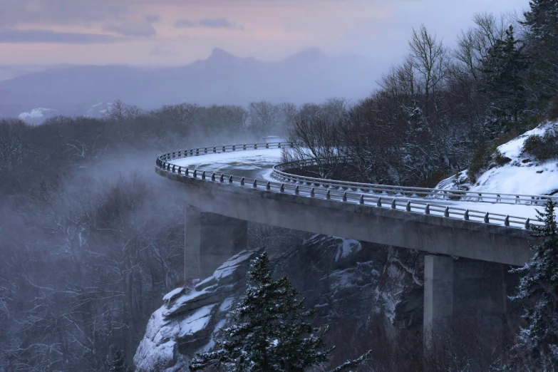 a freeway going over a snow covered mountain ridge