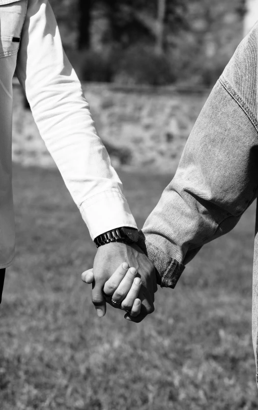 a close up of a person holding another persons hand