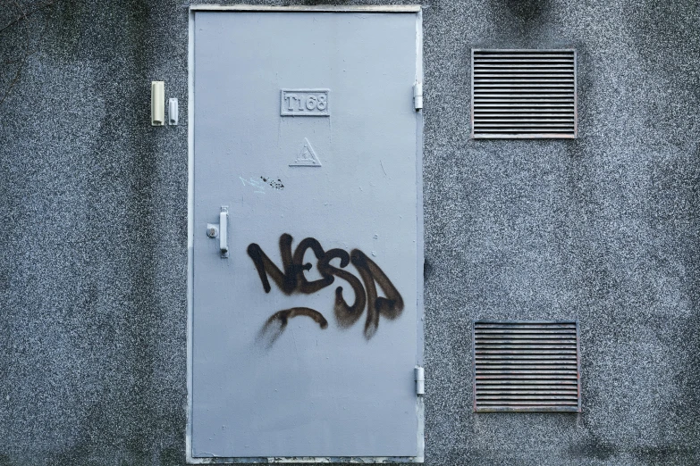 graffiti spray painted on the side of an open door