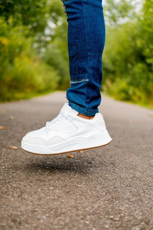 a person's foot is seen as they are riding down the street