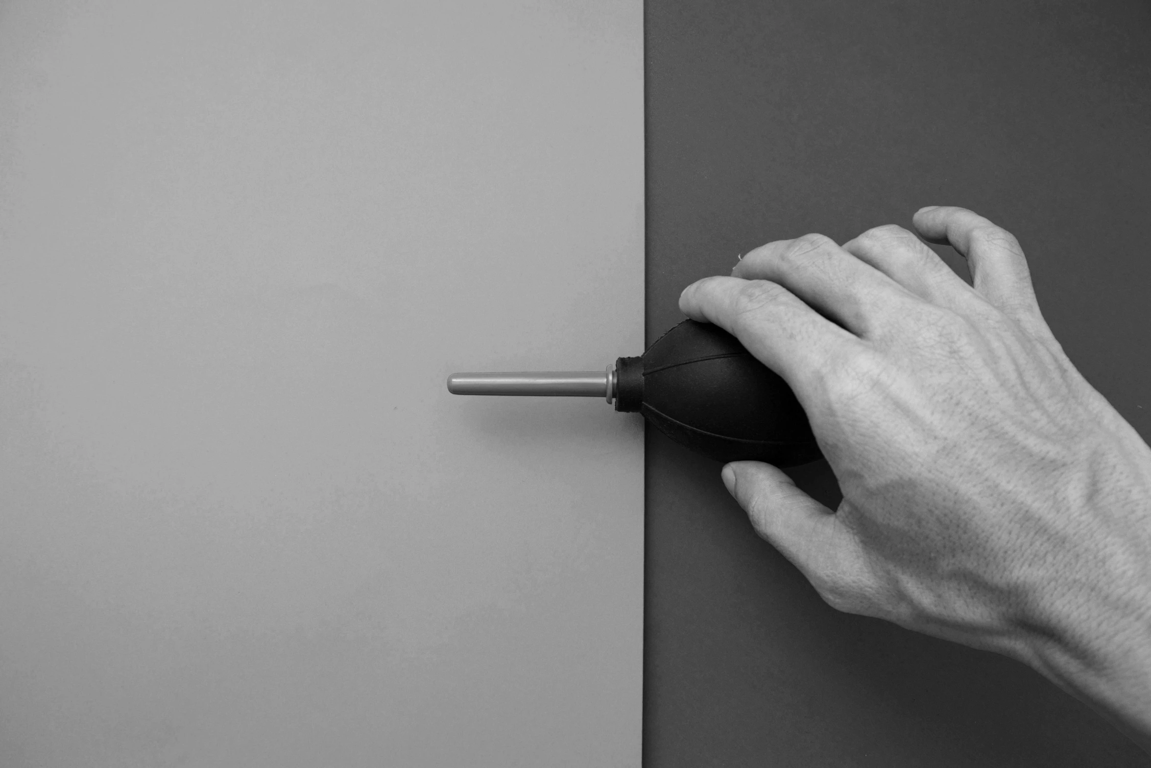 a hand is locking the handle on a wall