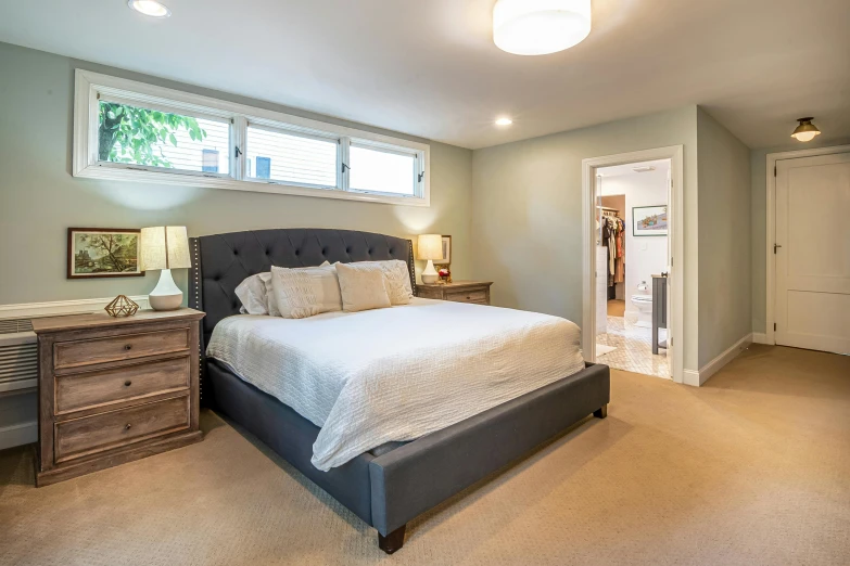 a clean, comfortable master bedroom with its own bathroom
