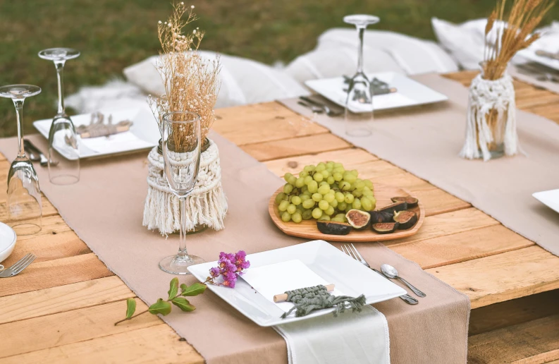 an outdoor dining table is set up for a meal