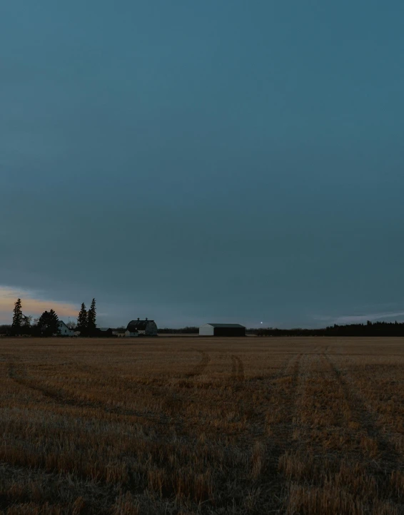 a po of a field with a barn