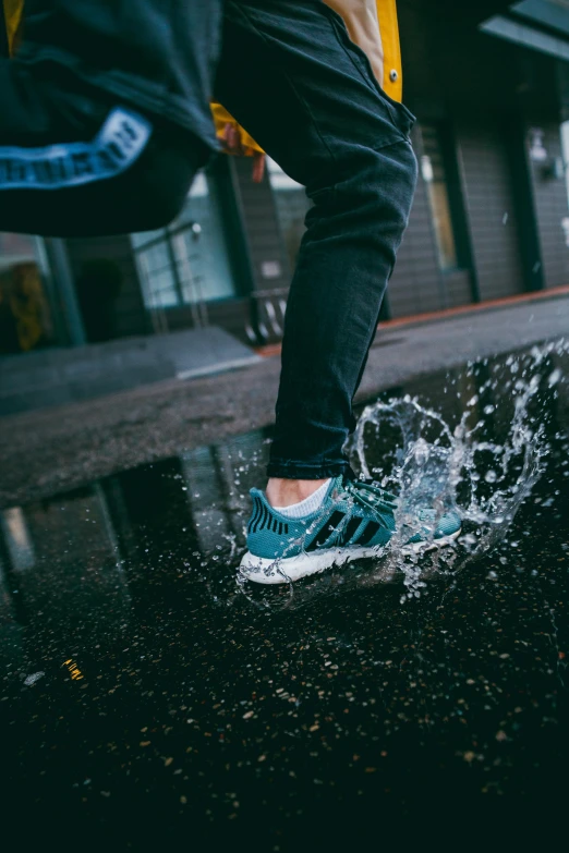 a man walks in rain on the side walk