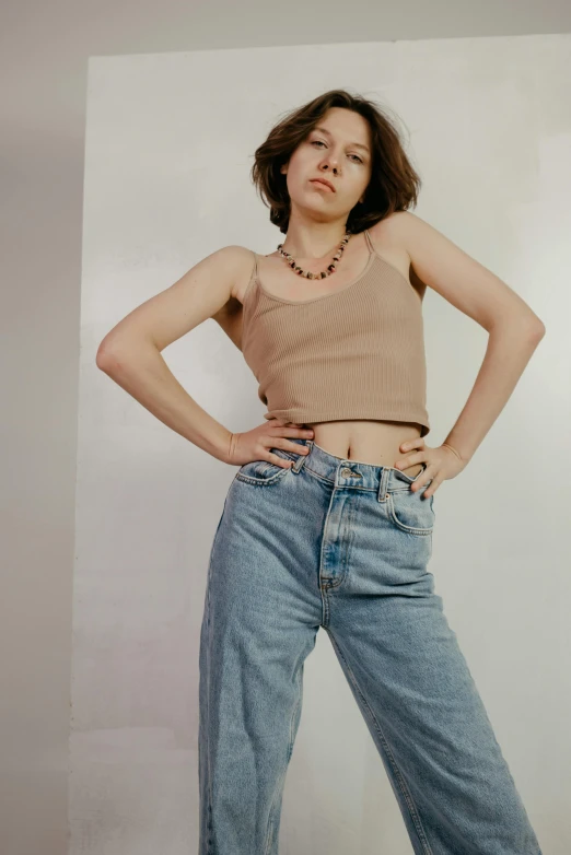 a woman posing for a po in front of a white background