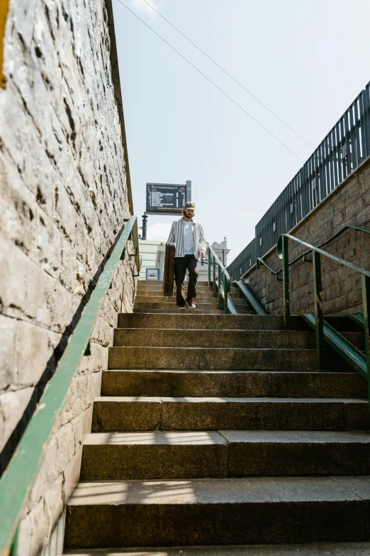 two people walking up a stairway and the stairs lead up