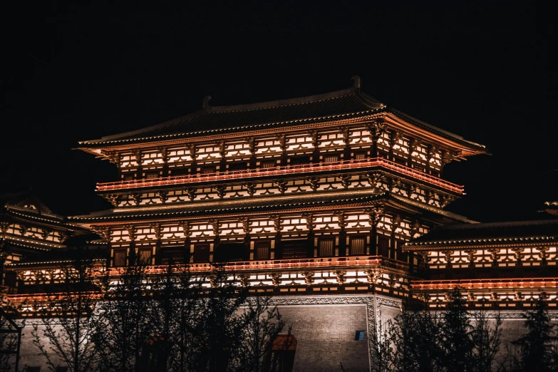the exterior of a building lit up at night