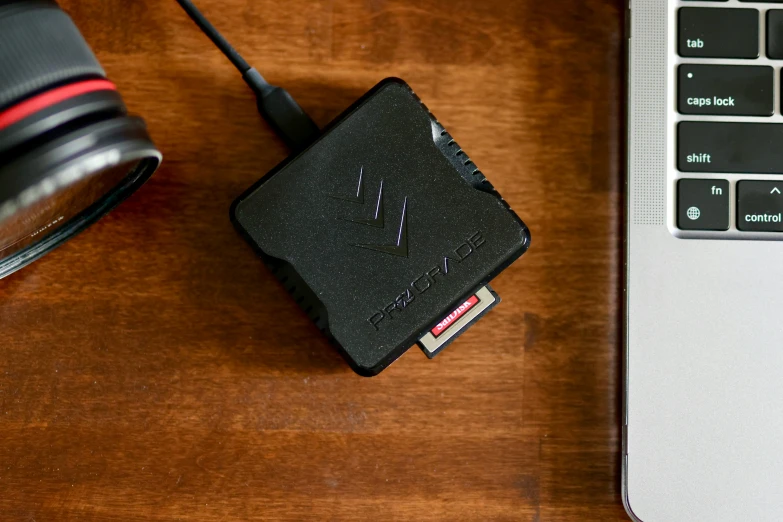 a laptop computer sitting next to a tiny camera