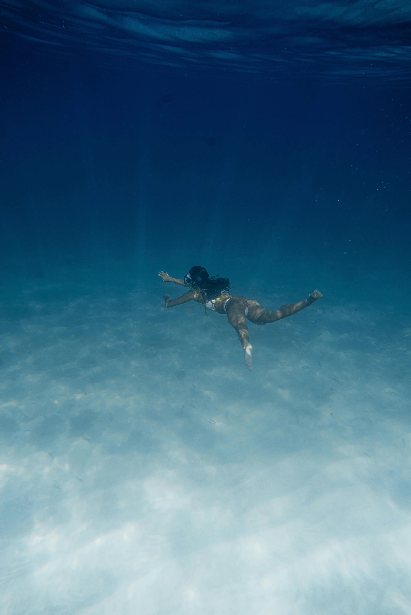 person floating on the water with their arms up