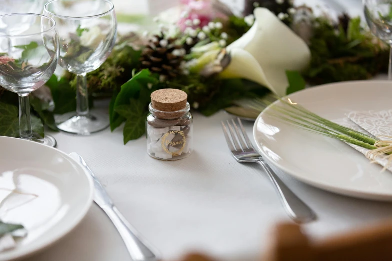 flowers sit on the table next to an empty jar