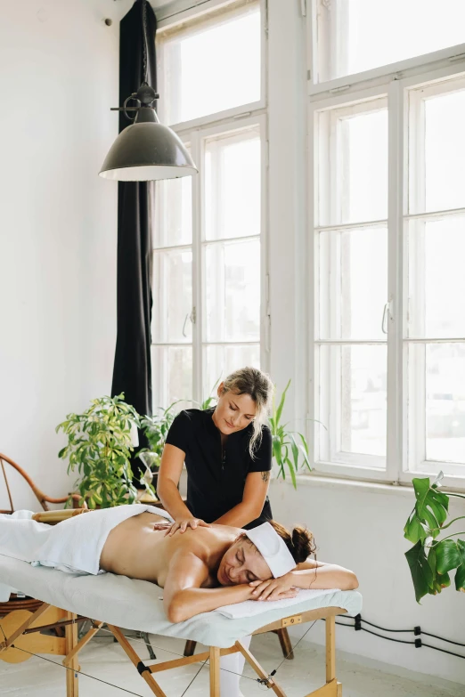 a woman is getting her back examined in a massage