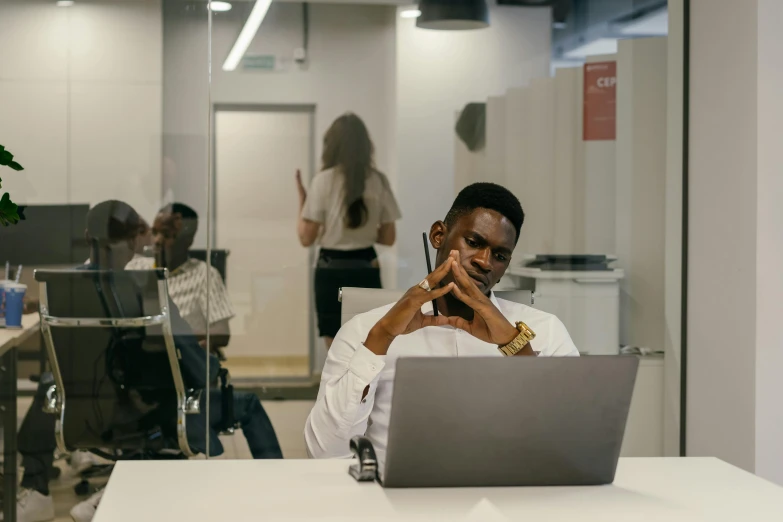 a young black businessman looking around in an office